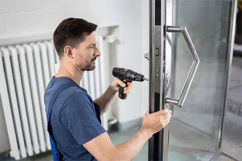 emergency commercial locksmith working on an office door